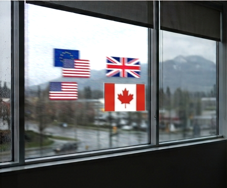 Flags of the European Union, the United States, the United Kingdom and Canada in an office window